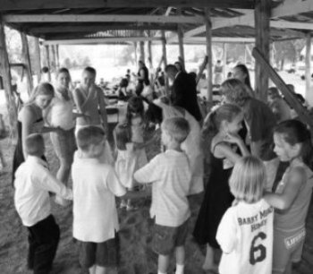 Bride and Groom Dancing with the Children in a Pole Barn